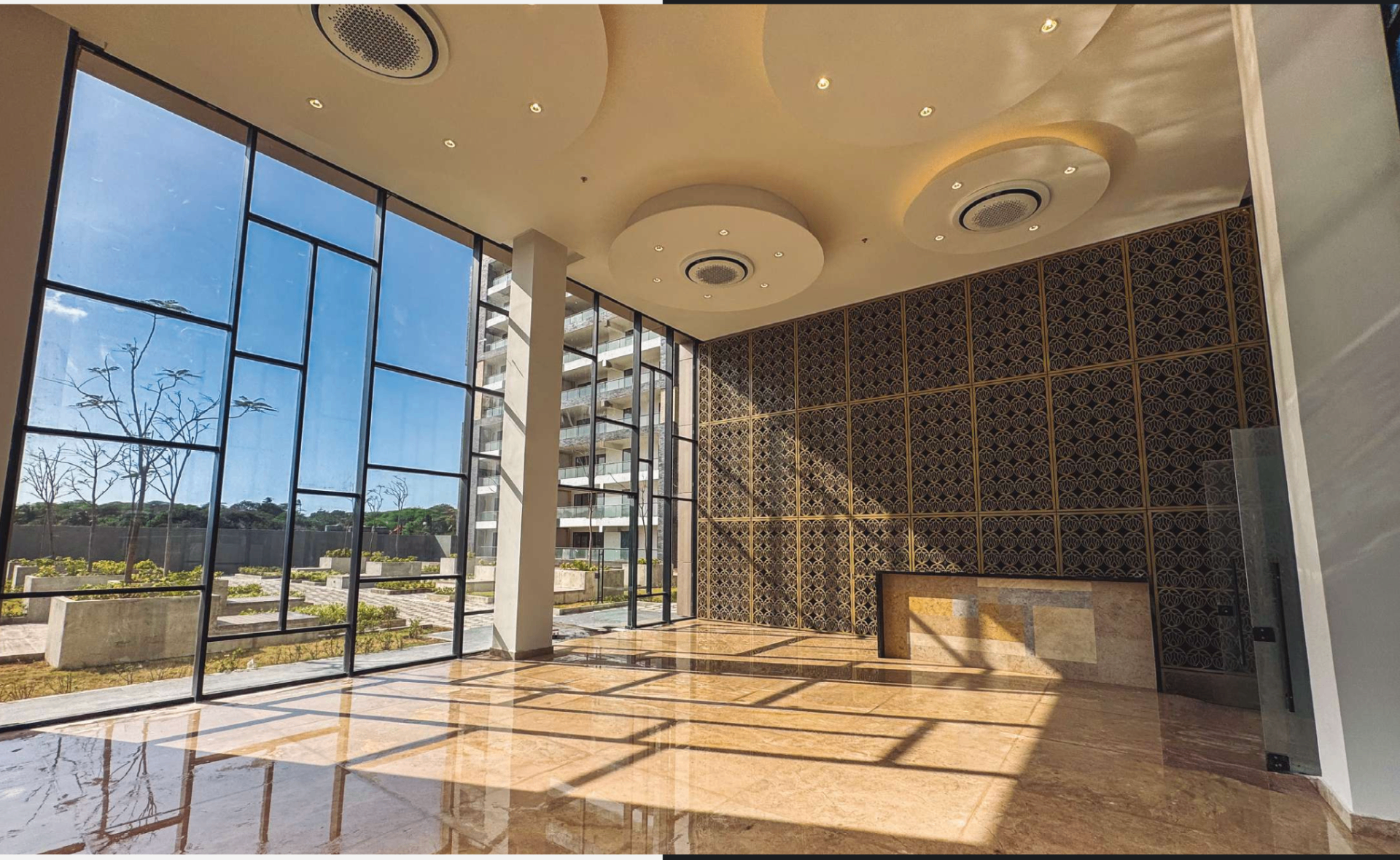 Alto Lago double-height marble lobby with patterned gold screen